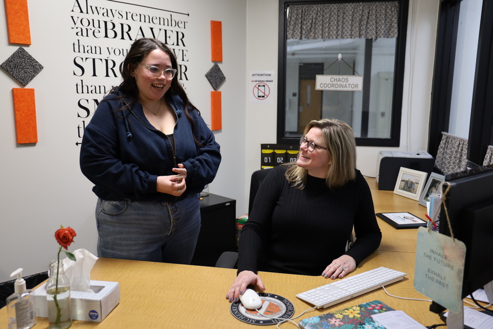 Staff Member of the Month Nicole Hodges talks with her helper senior Vanessa Schroeder