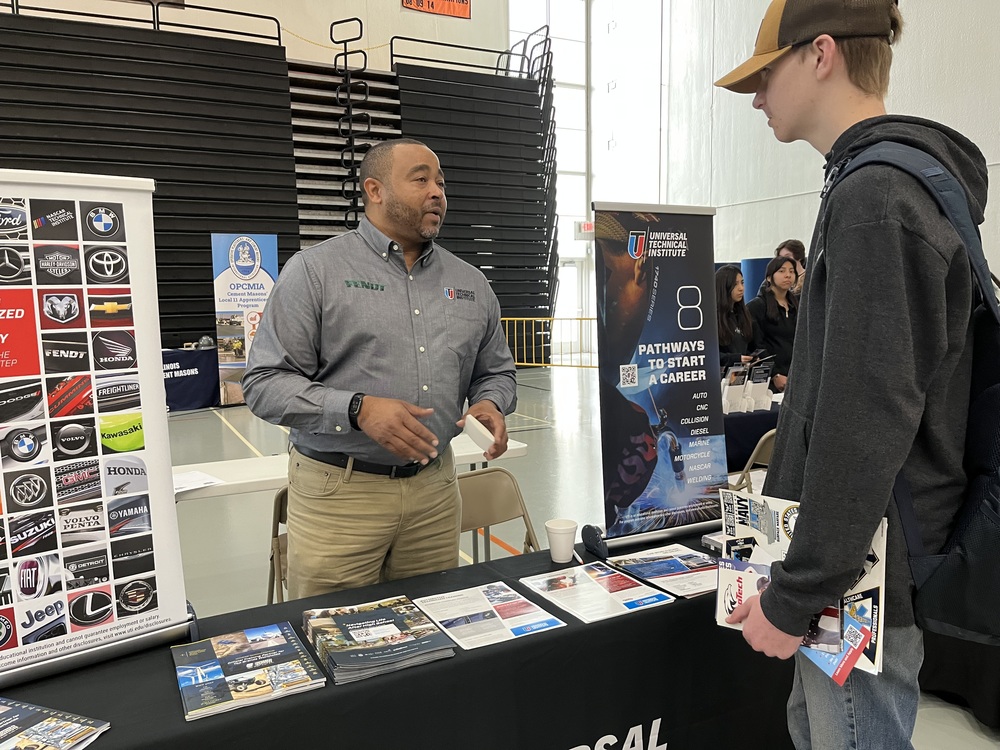 Danny Parker of Universal Technical Institute talks to a MCHS student at the College and Career Expo