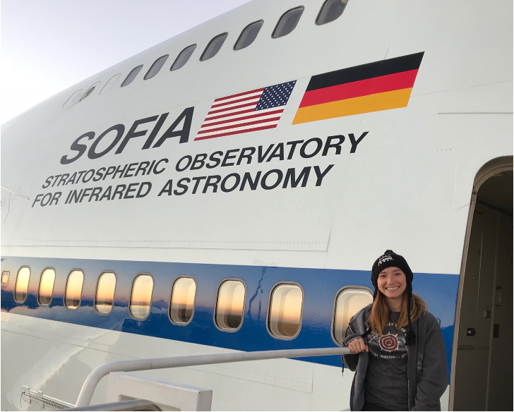 Casey Honniball in front of the SOFIA airborne telescope