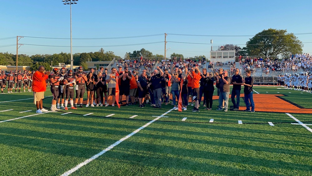 MCHS students, staff and board members gather to cut ribbon for new turf field at McCracken