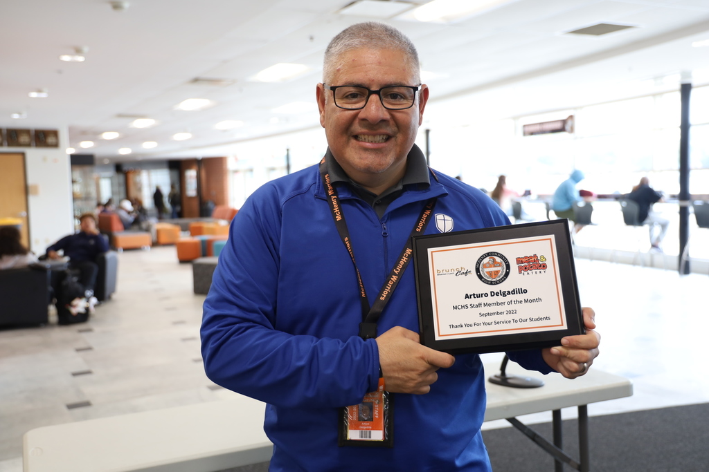 Art Delgadillo holding his Staff Member of the Month plaque