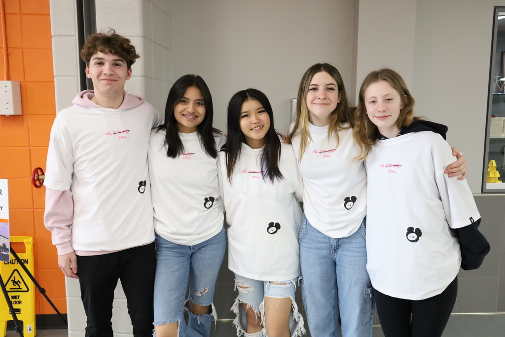 Five students in matching t-shirts