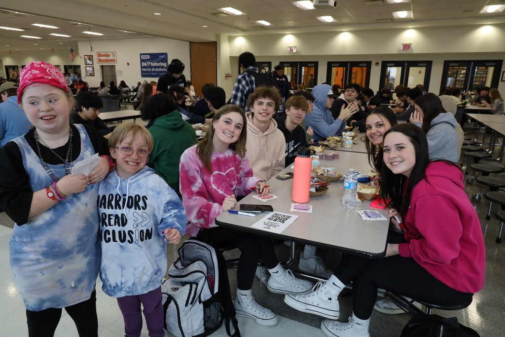 Students posing at a lunch table