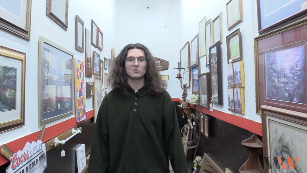 A student standing at an antique store