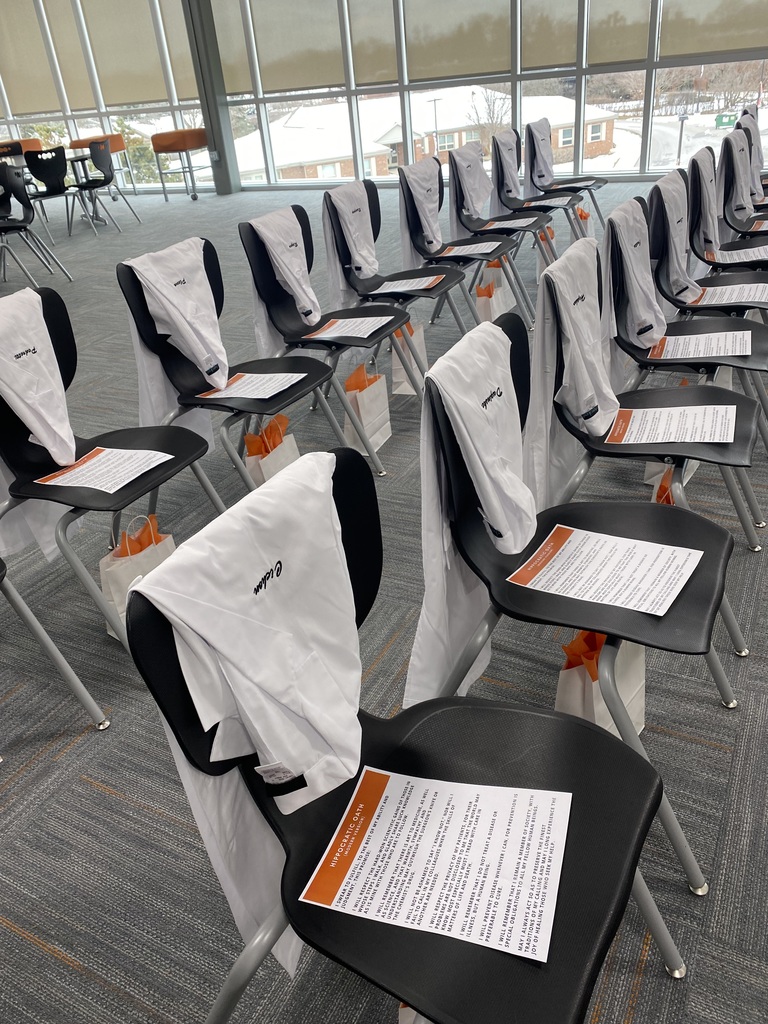 The white coats draped over chairs