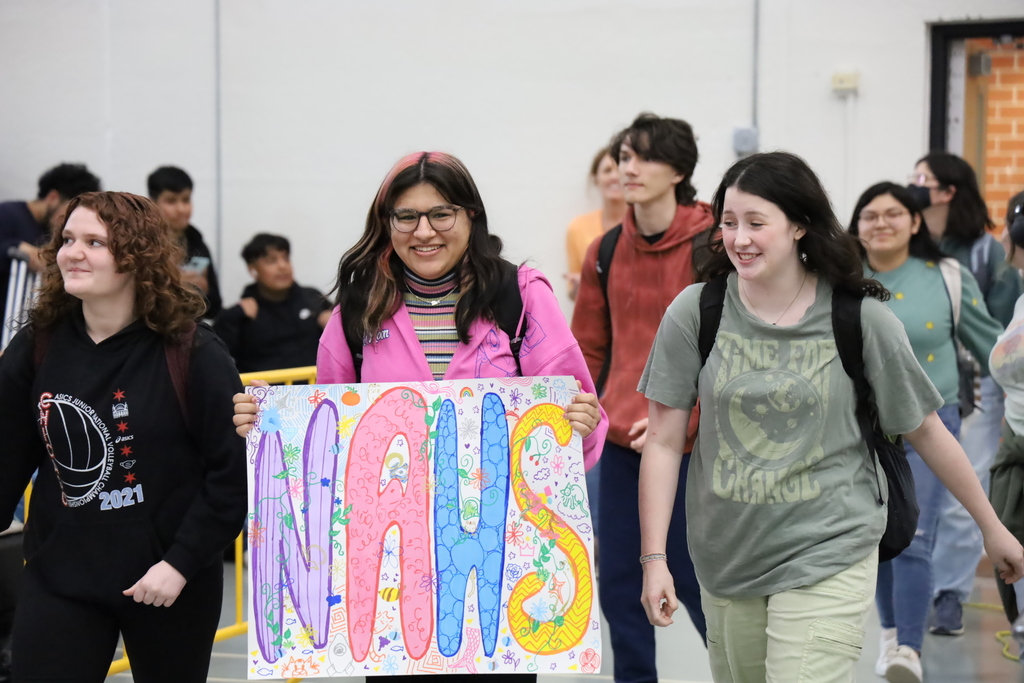 Students holding a NAHS sign