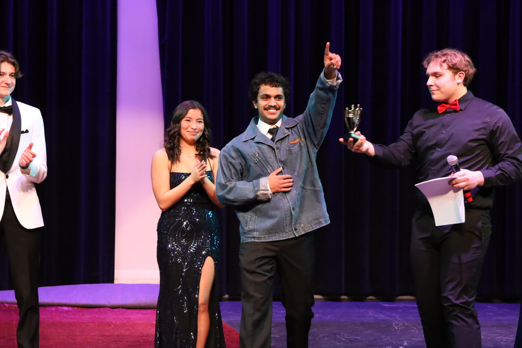 Rayaan and Mara being and Rayaan being presented with a trophy by Eli
