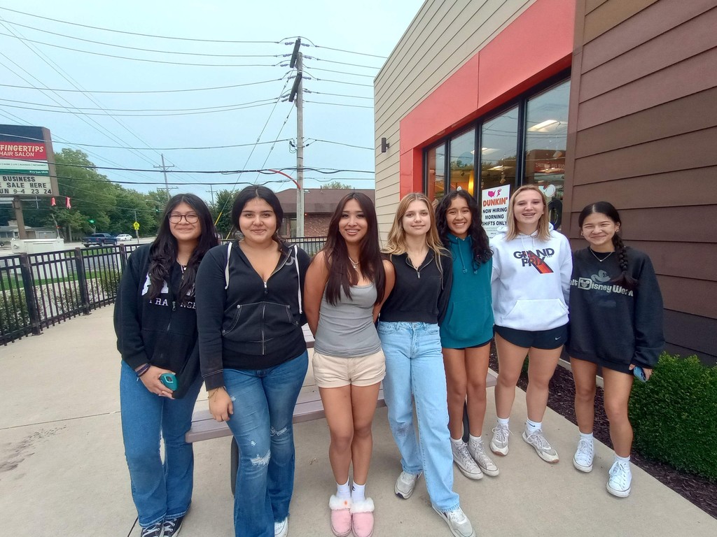 A grop of students in front of Dunkin Donuts