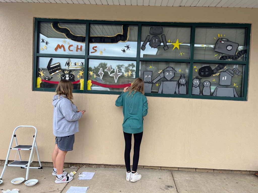 Students painting a window